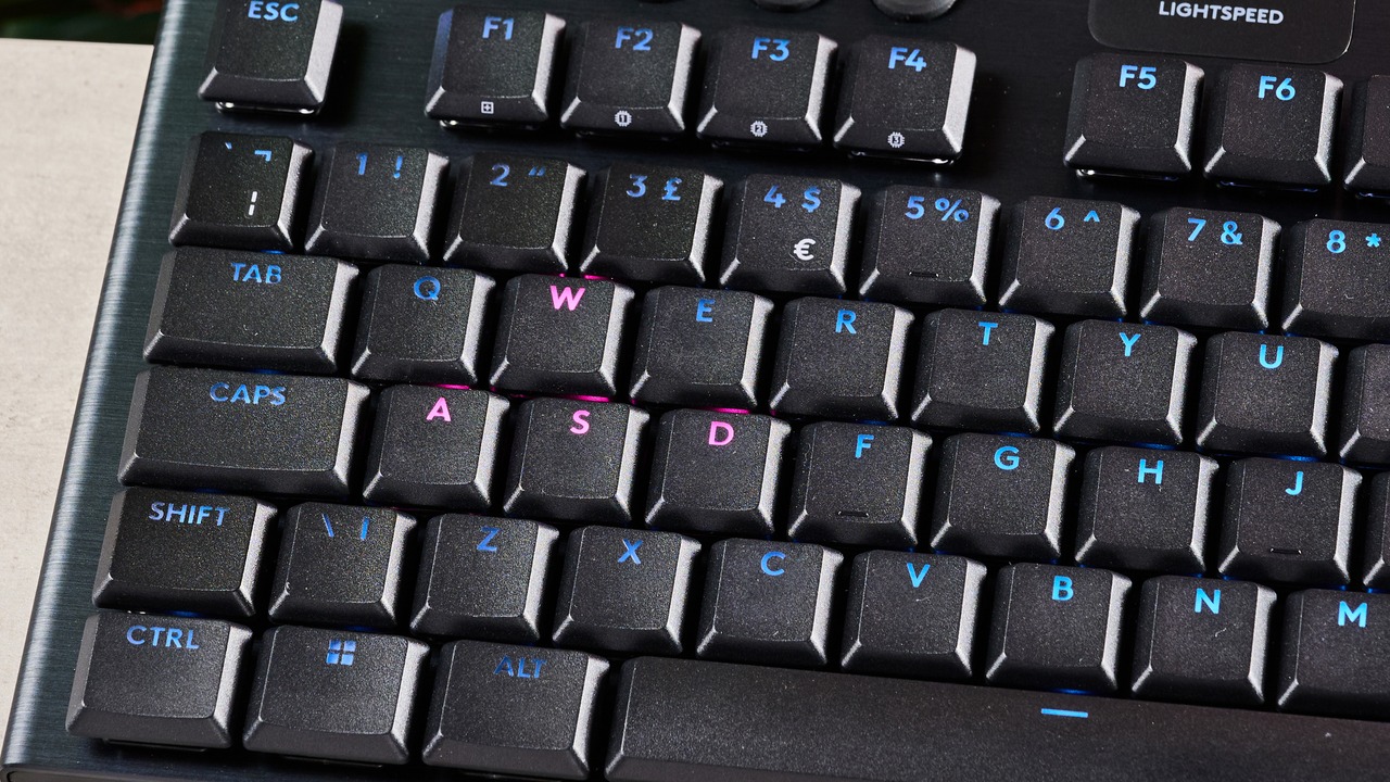 Cận cảnh góc bên trái của bàn phím Logitech G915 X TKL với đèn LED RGB sáng rõ trên các phím và phần viền nhôm phay xước.